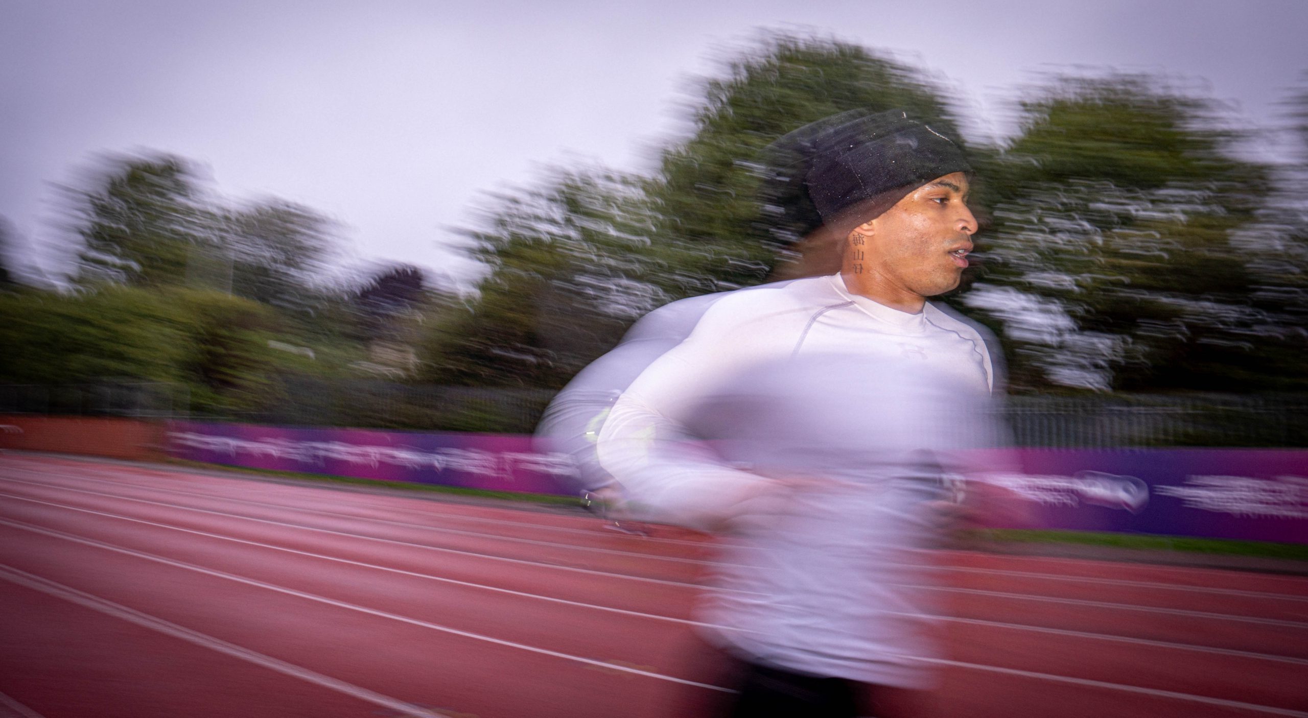 Student running on an athletic track