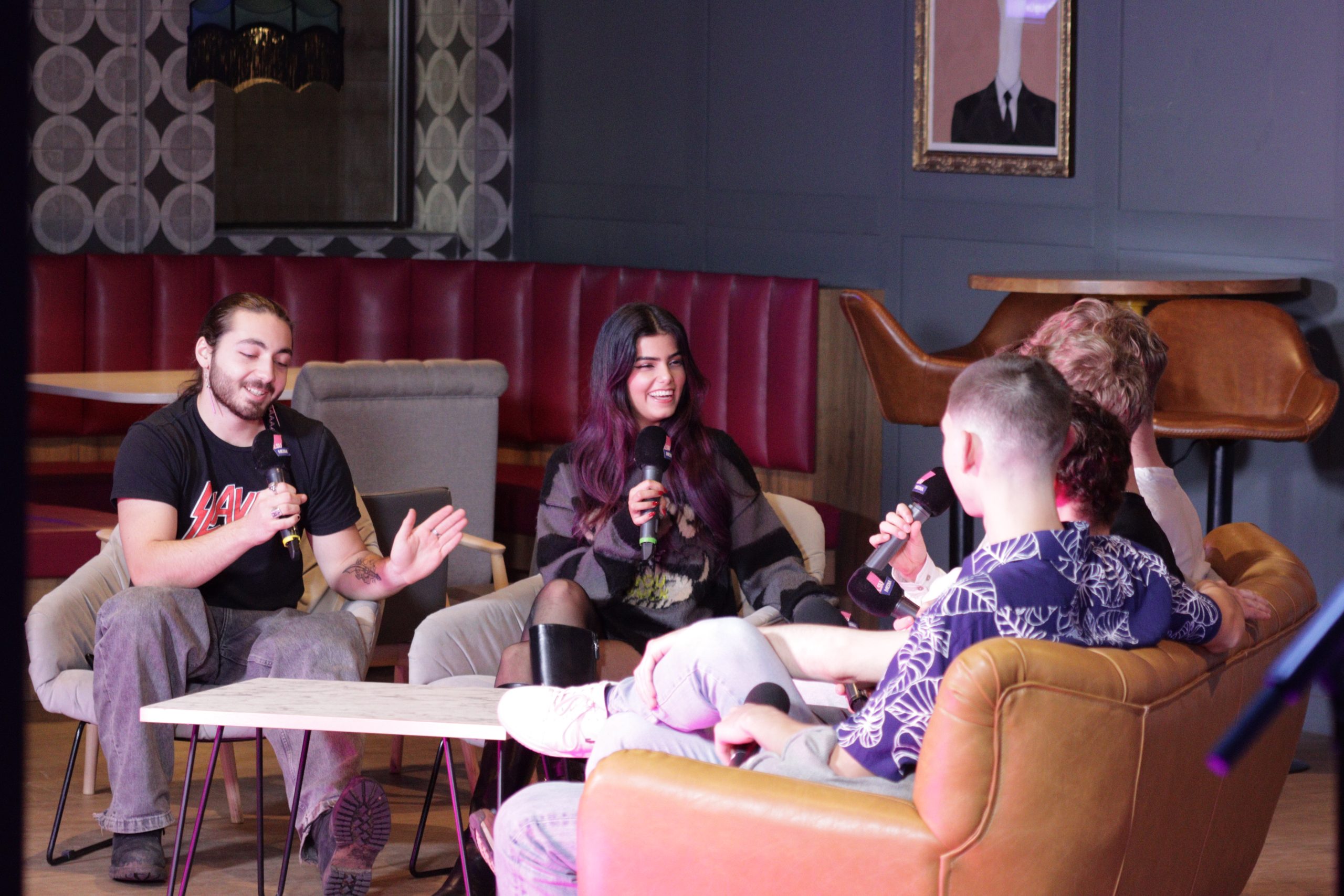 students interviewing other students in the student's union in a group sat down