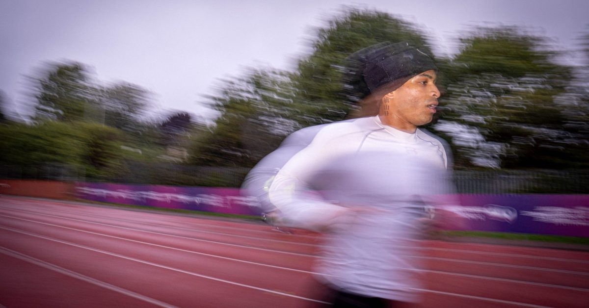 Student running on an athletic track